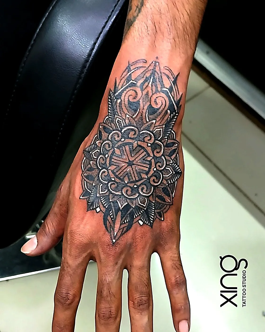 Geometric mandala tattoo on the back of the hand