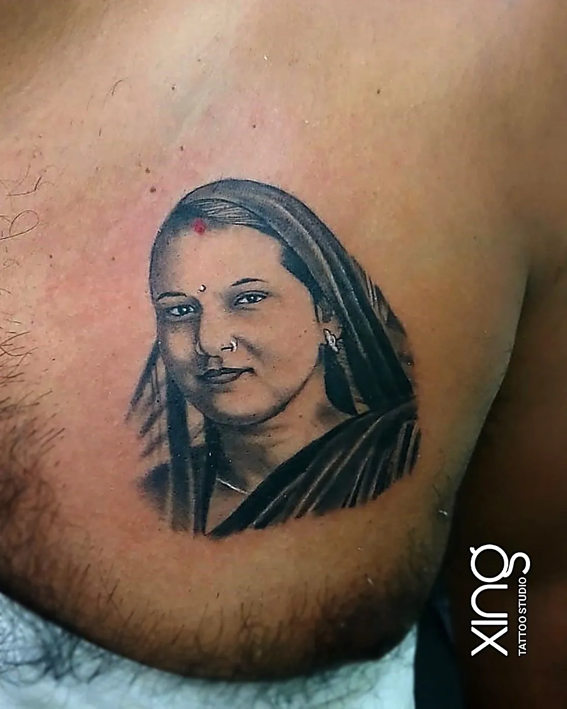 Realistic smiling portrait tattoo of a man on chest