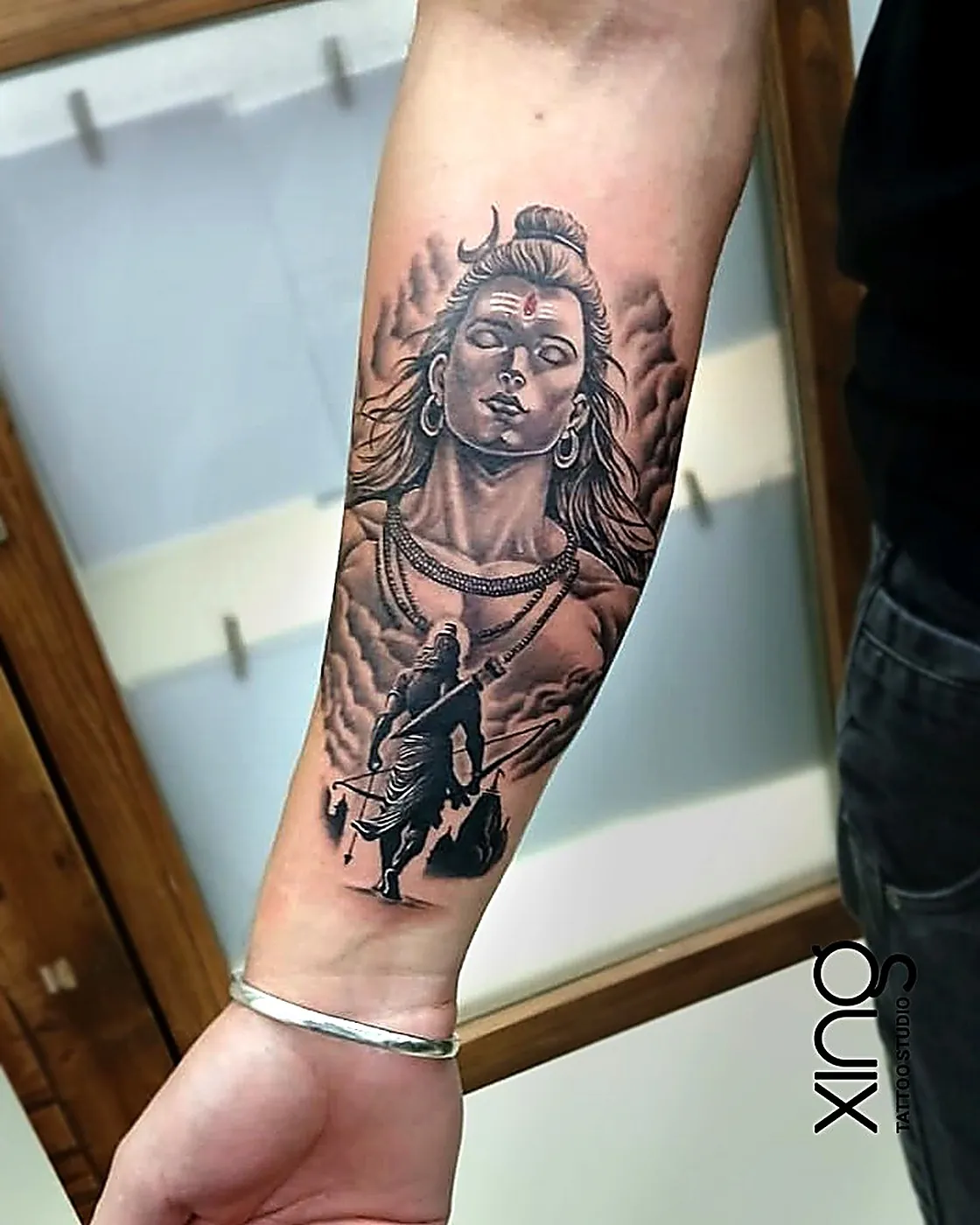 Realistic Lord Shiva portrait tattoo on forearm