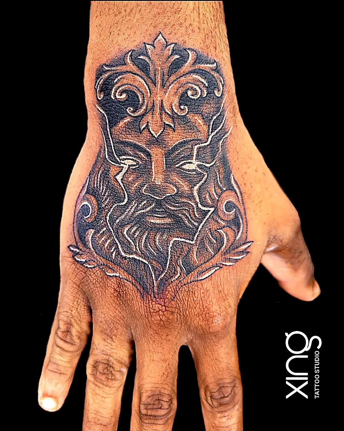 Bold ornamental face tattoo on the back of the hand at XING Tattoo Studio, Bengaluru