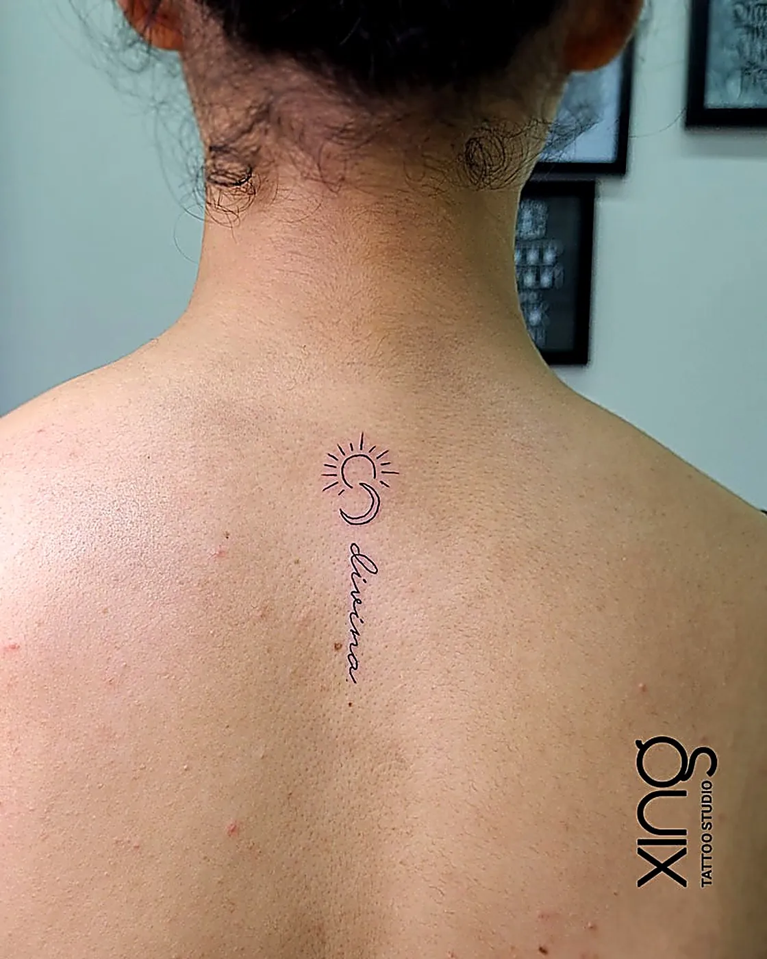 Fine-line sun, moon and script minimalist tattoo along the spine at XING Tattoo Studio, Brookefield, Bengaluru